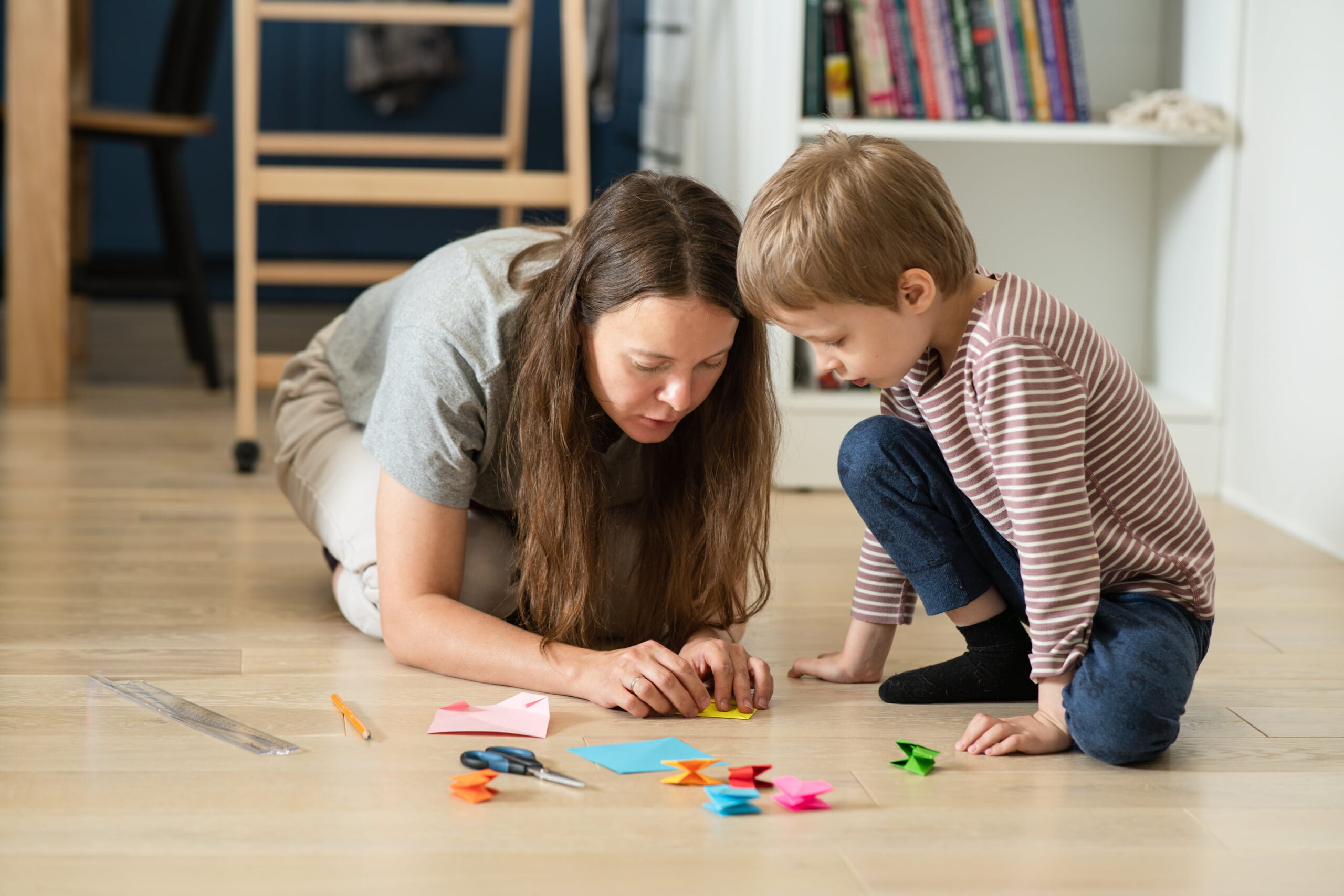 young-mother-teaches-her-son-to-fold-origami-paper-2025-01-07-12-35-04-utc